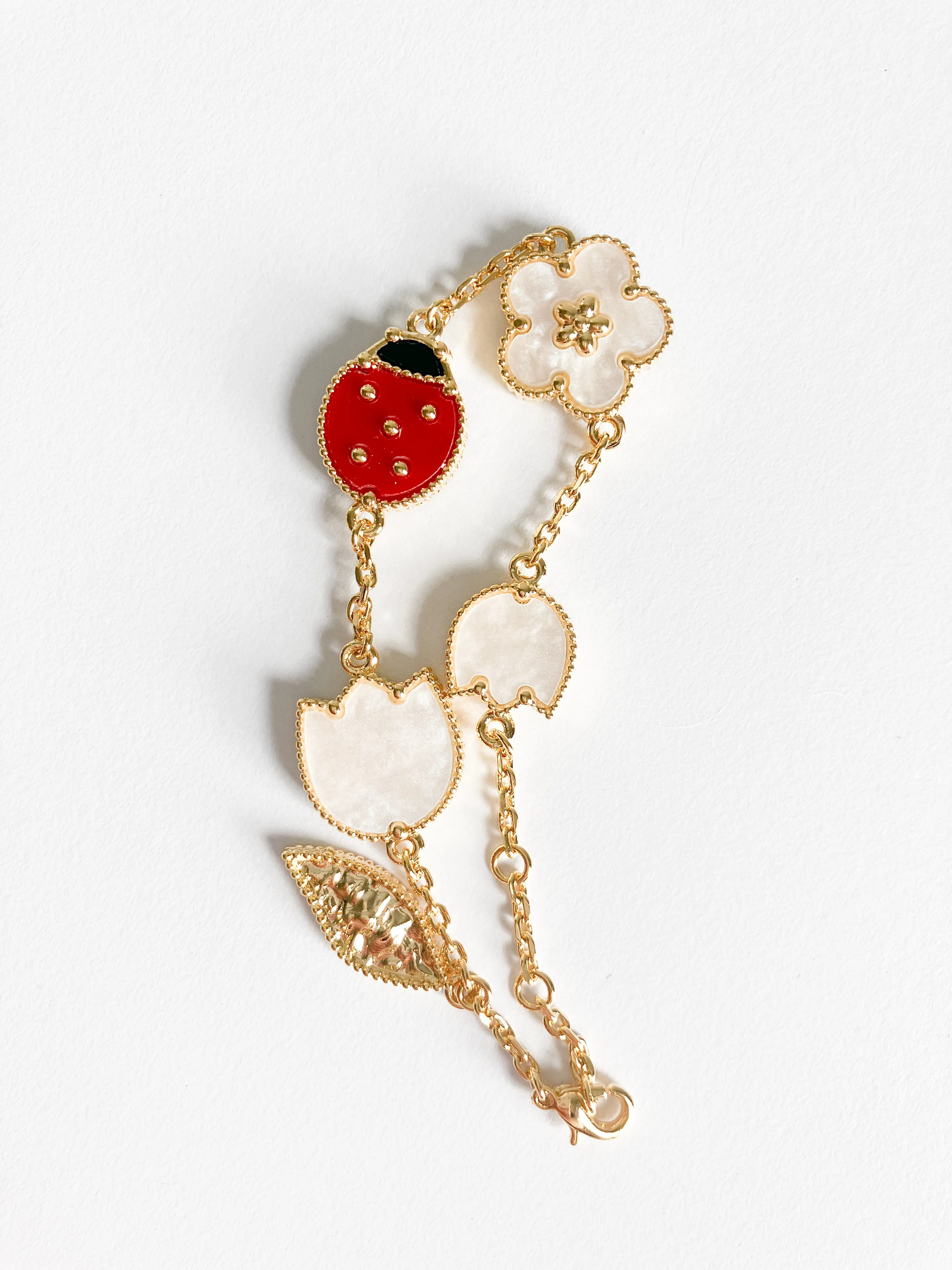 Carnelian, Onyx, and Mother of Pearl Ladybug and Flowers Bracelet in Gold