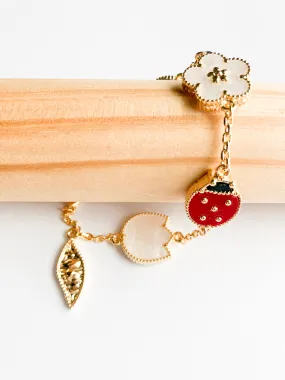 Carnelian, Onyx, and Mother of Pearl Ladybug and Flowers Bracelet in Gold